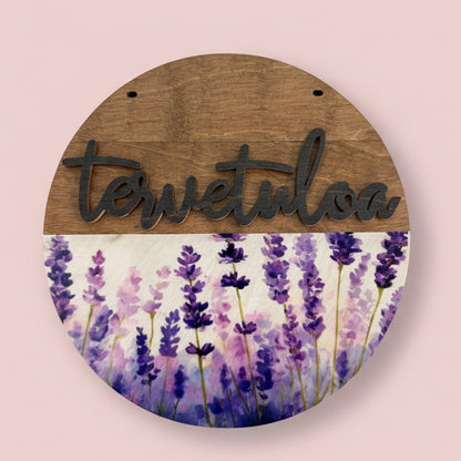 Kesäkukka teemainen ovikyltti tervetuloa-tekstillä.